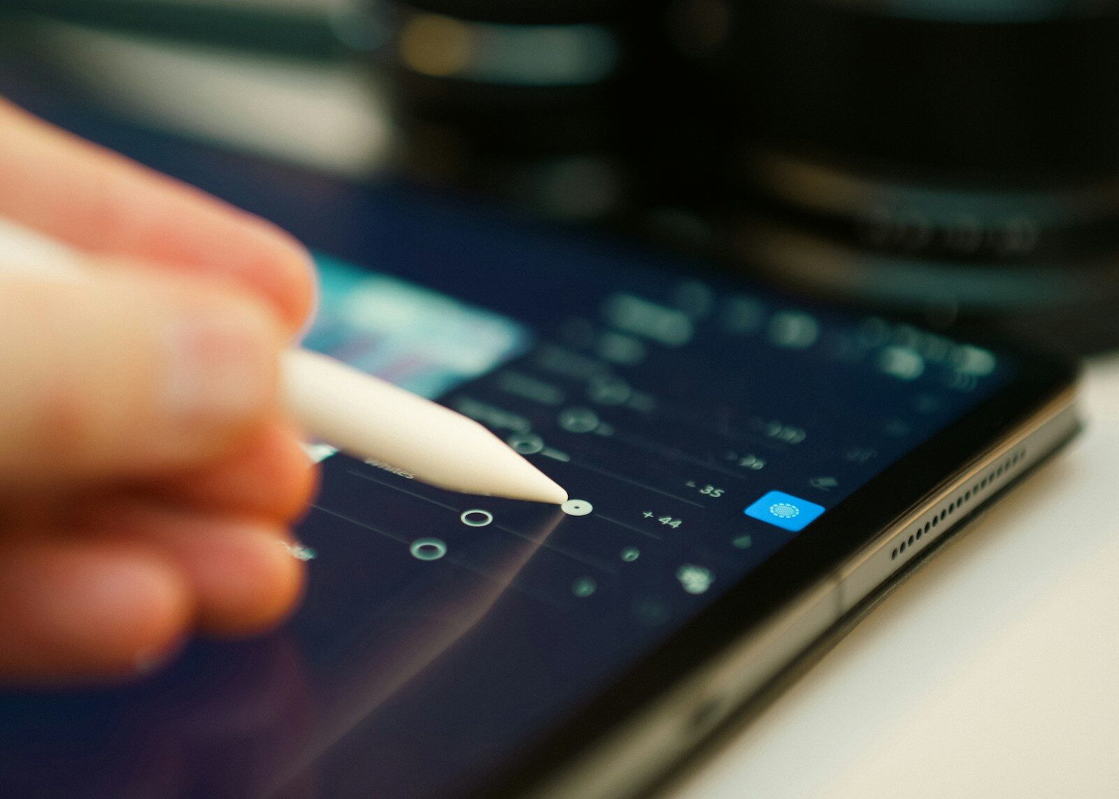 Someone is editing with a stylus on a tablet.